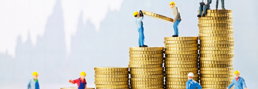 Pile of gold coins with construction toys climbing on the coins