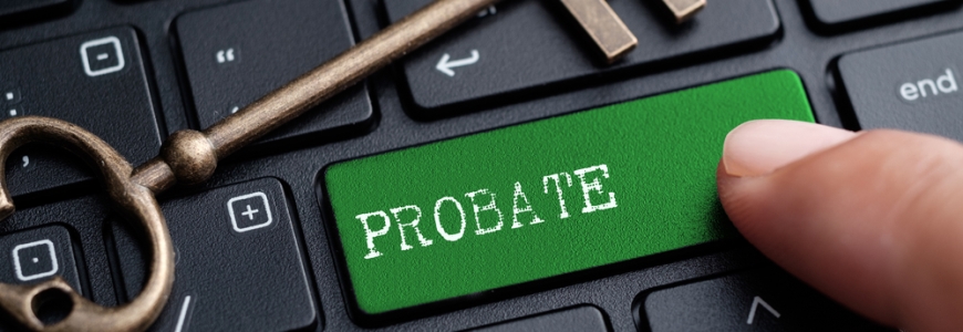 Keyboard with the word PROBATE on one of the keys with a hand pressing it. A led key is in resting on the keyboard.