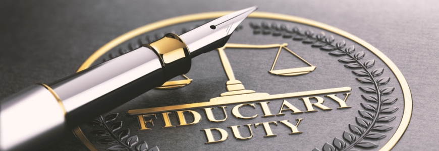 Plaque with words Fiduciary Duty written on it and a very stylish calligraphy pen on top