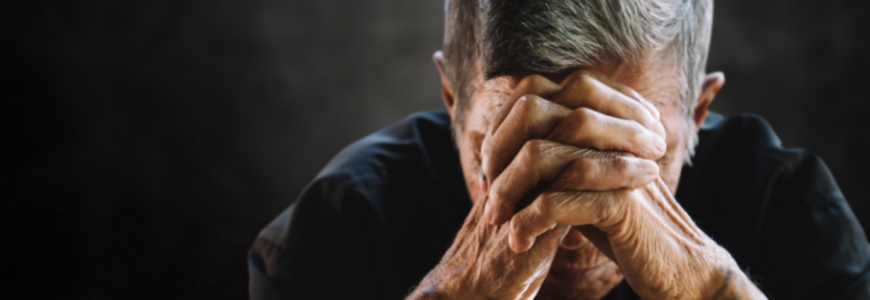 Senior man covering his face with his hands. Depression