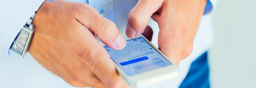 Close up of a man's hands texting from a cellphone