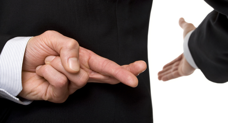 Crossed fingers behind back while reaching other hand out for a handshake