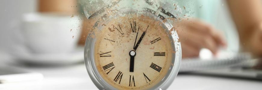 Crumbling alarm clock on white table in office