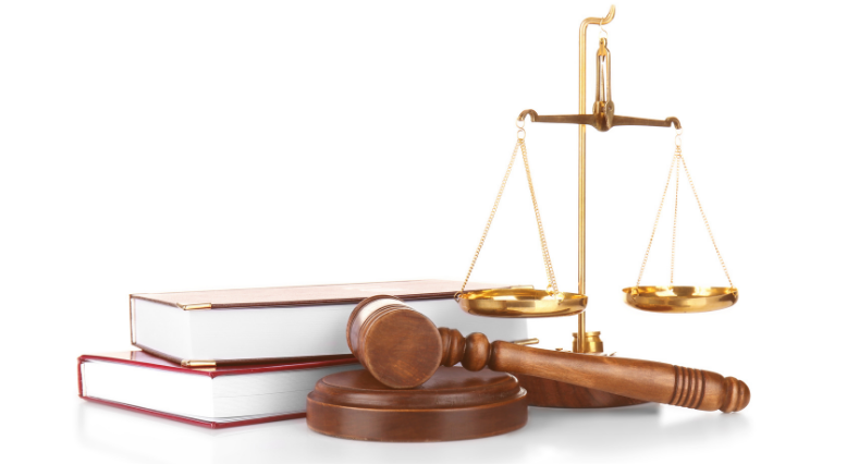 Judge gavel, scales and books on white background