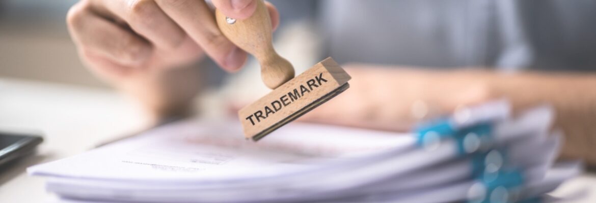 Trademark Protection Rubber Stamp On Paper In Office.
