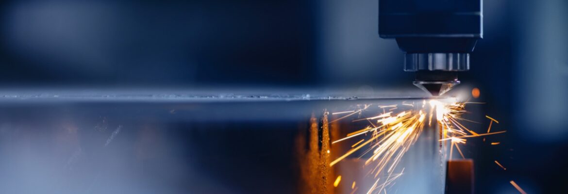 Blue color Laser CNC cut of metal with light spark, technology modern industrial.