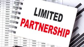 LIMITED PARTNERSHIP text on notebook with chart and calculator
