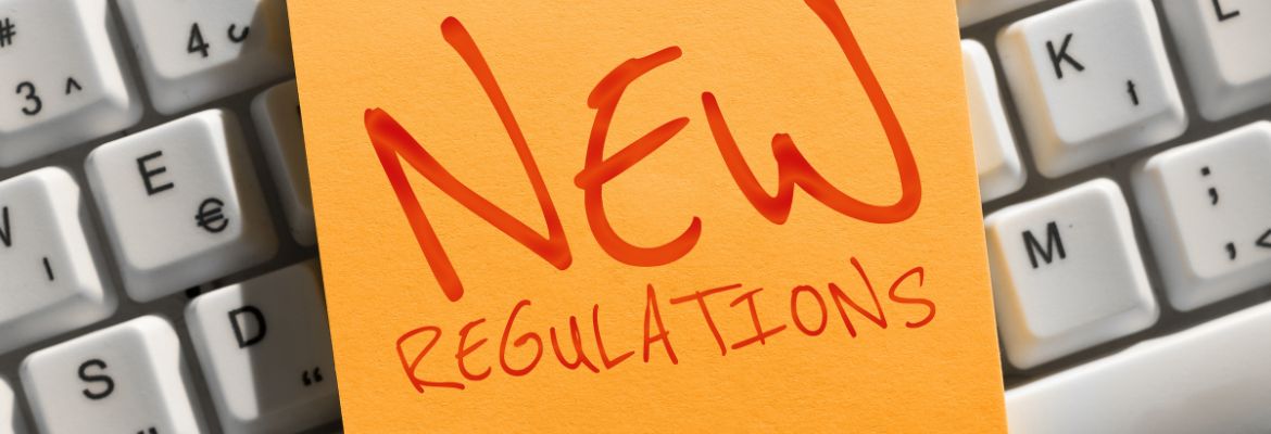 Writing on a post-it note displaying the text "New Regulations"