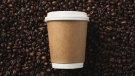 Blank coffee cup on coffee beans background