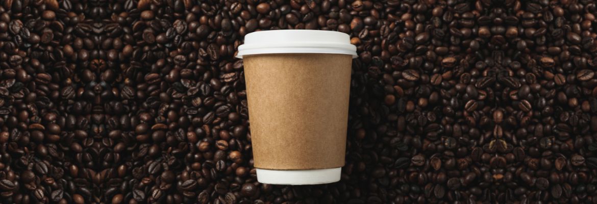 Blank coffee cup on coffee beans background